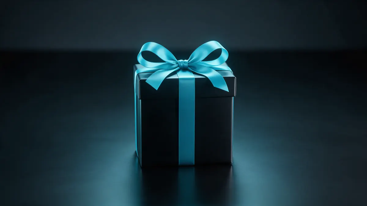 A gift box with a cyan ribbon on a dark surface.